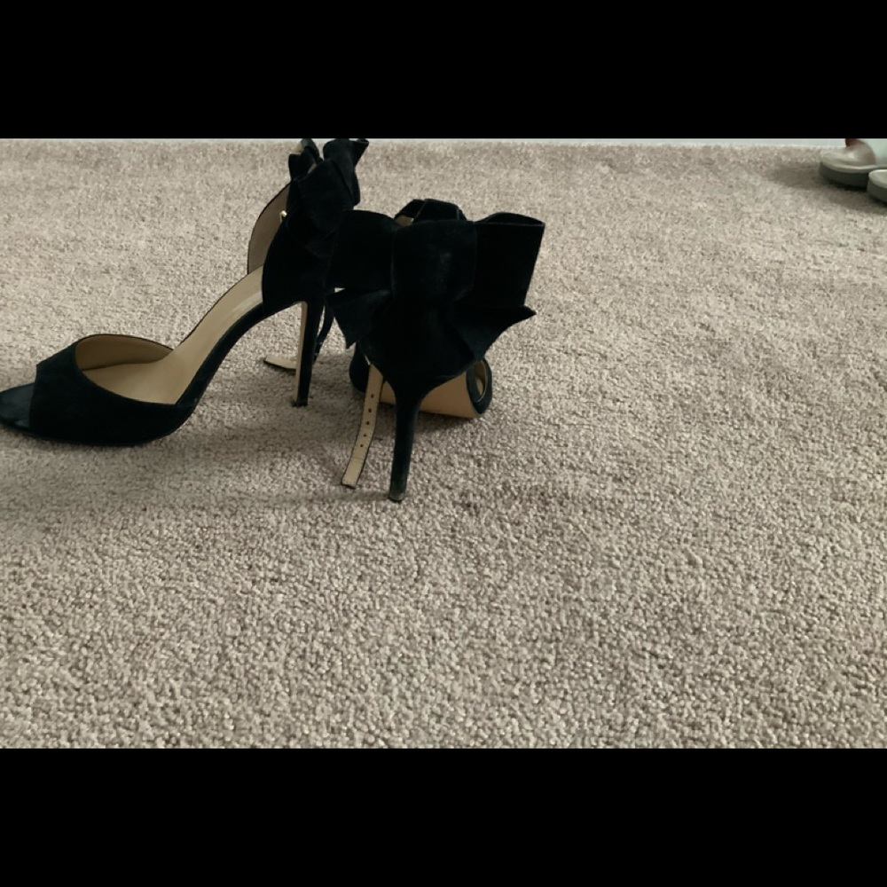 Black suede heels with bow on the back
